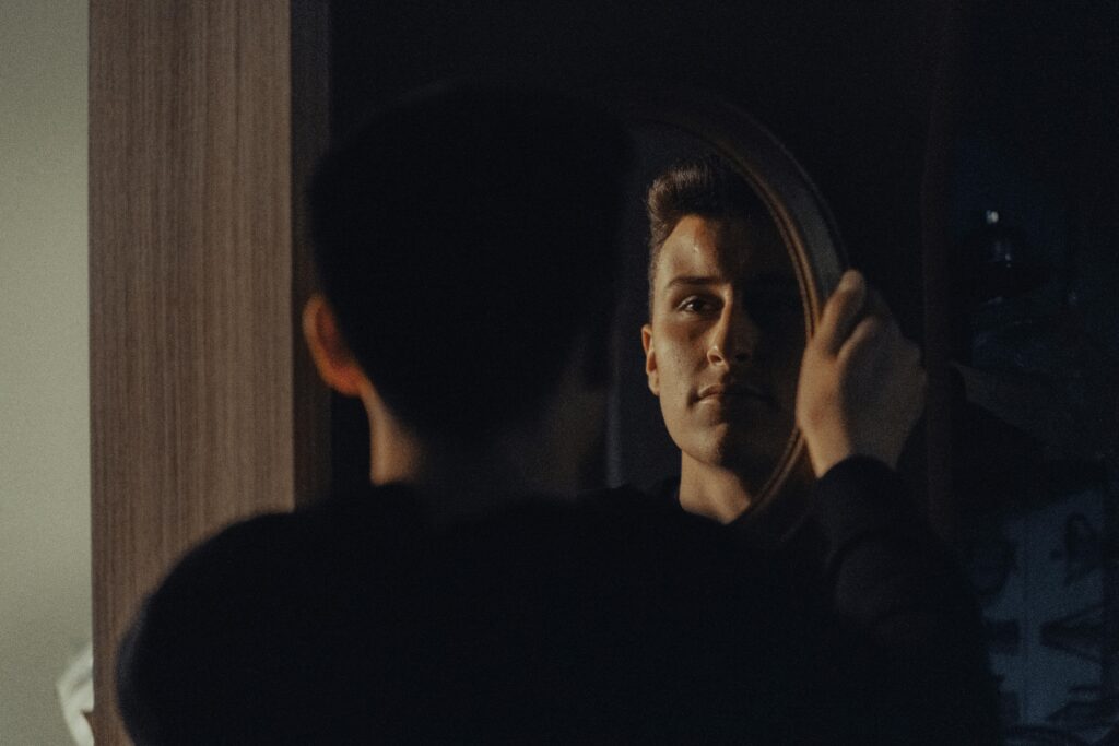 Man Reflecting in Mirror