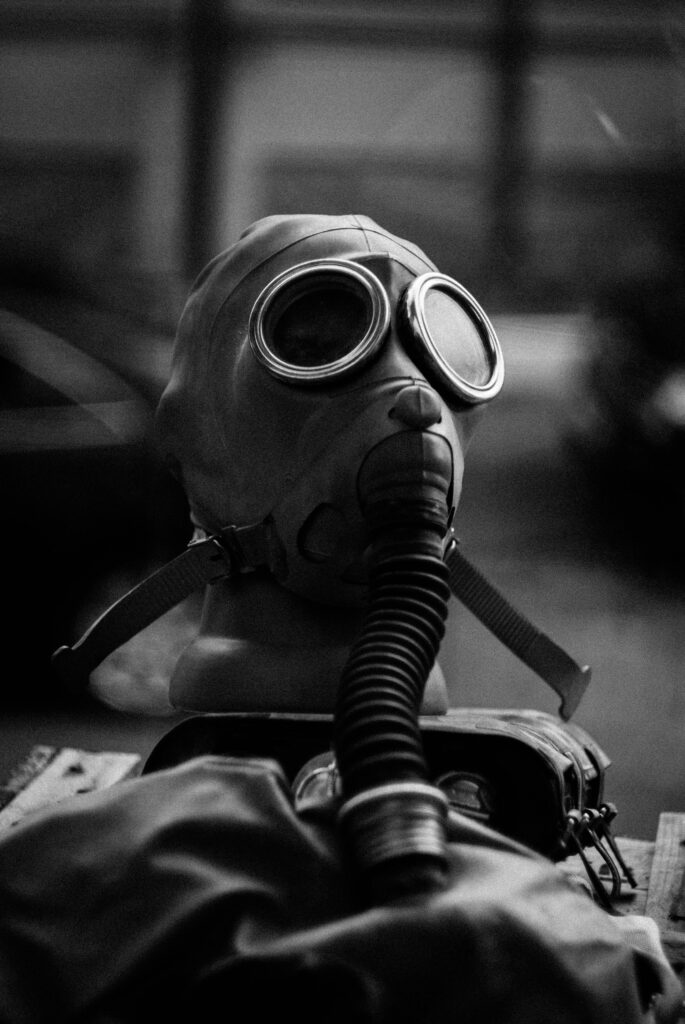 pexels-photo-3621076-3621076 Grayscale image showcasing a vintage gas mask on display, emphasizing safety and protection themes.