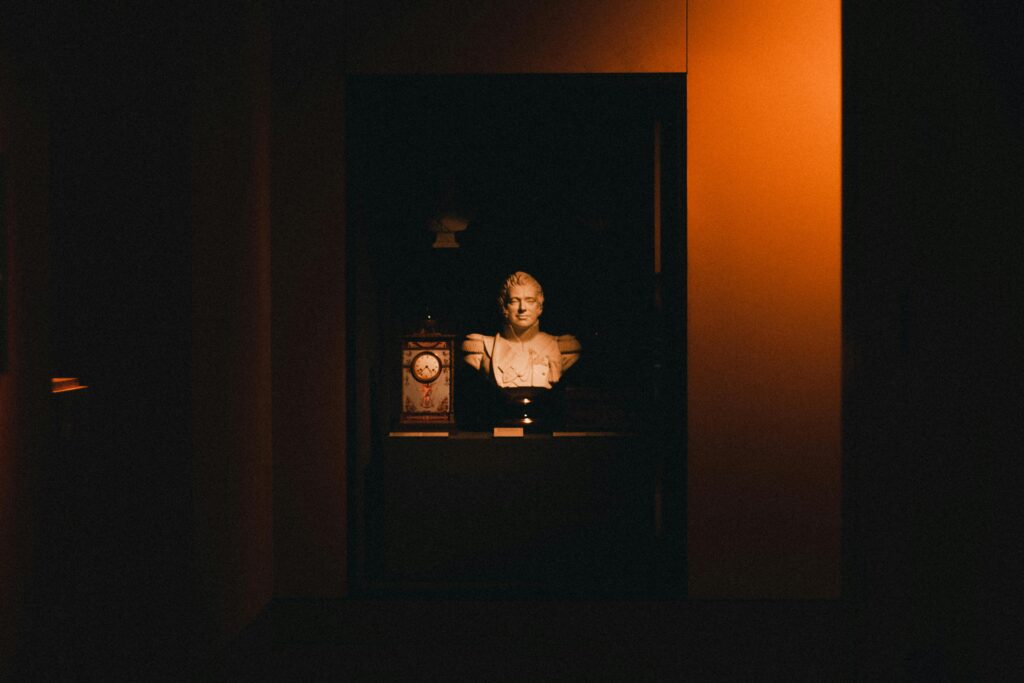 pexels-photo-6896368-6896368 A dramatic display of an ancient Greek bust with contrasting shadows, highlighting its historic elegance.